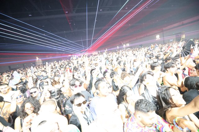 Massive Crowd Surges Under Laser Light Show