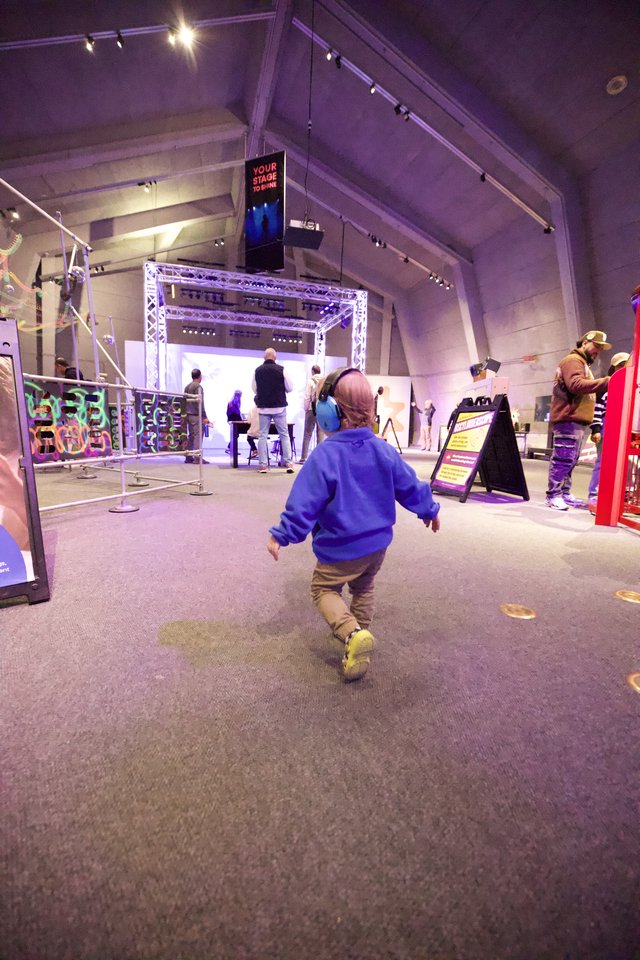 Child Running Through Interactive Museum Exhibition Space