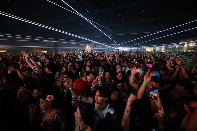 Massive Crowd Surges Under Laser Light Show
