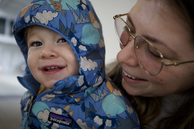 Joyful Winter Moment: Parent and Toddler Share a Smile