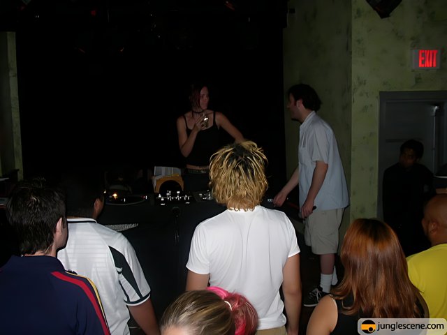 Nightclub Scene with DJ and a Crowd