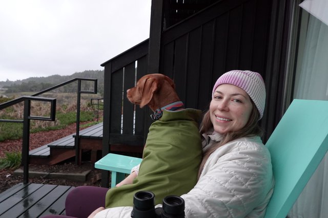 Woman and Dog Relaxing on Coastal Deck