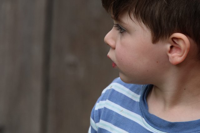 Young Boy in Profile with Contemplative Gaze