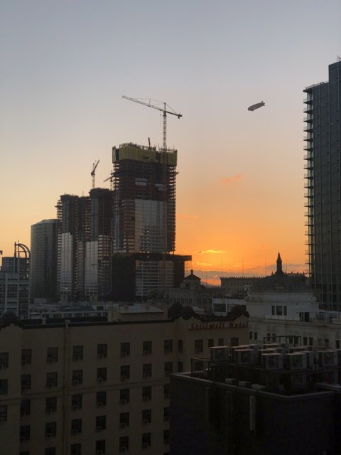Urban Sunset with Crane Flight