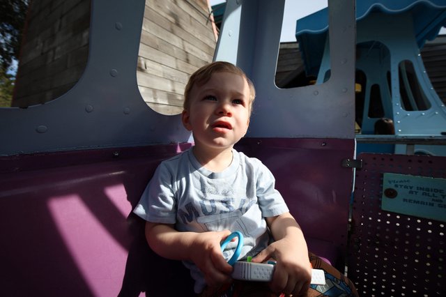 Toddler on Playground Equipment at Golden Hour
