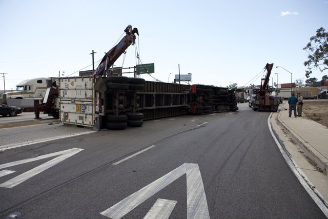 Crane Lifts Overturned Truck on Busy Street
