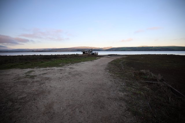 Abandoned Boat at Twilight on Coastal Estuary