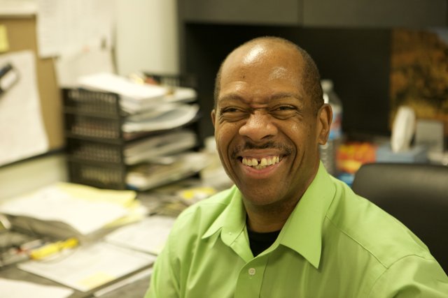 Smiling Executive in Green Shirt