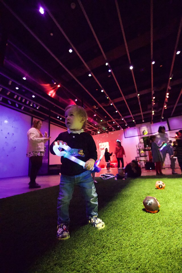 Child Plays with Light Toy at Asian Art Museum Baby Rave