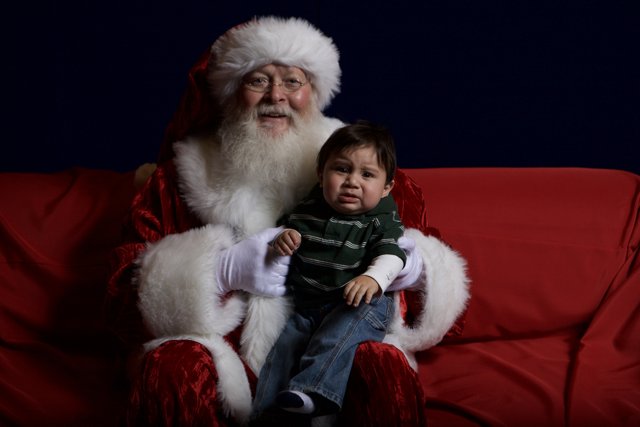 Santa Claus and Child on Festive Couch