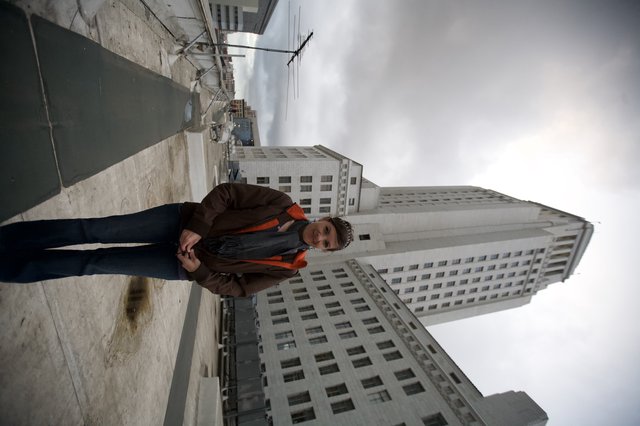 Woman Poses Atop Rooftop Before Los Angeles City Hall