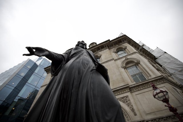 Monument Statue Pointing Forward Against Historic London Architecture