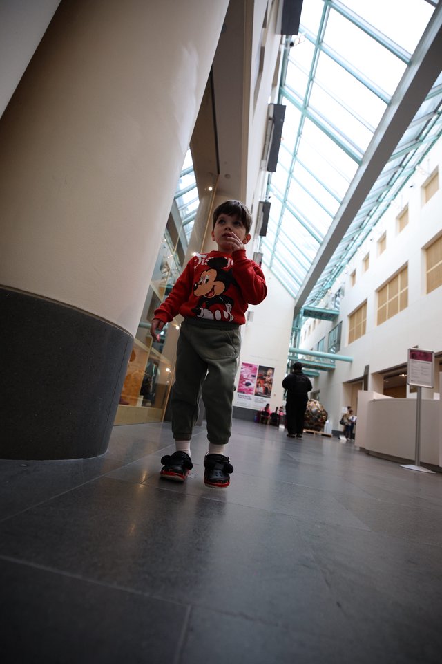 Young Child Exploring Modern Museum Atrium