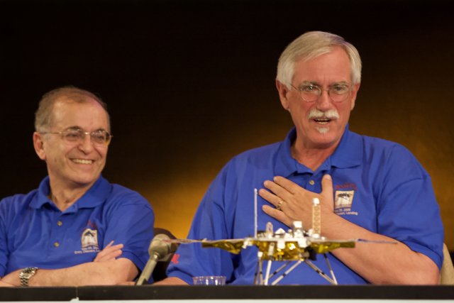 Two Men Discuss Mars Rover Model