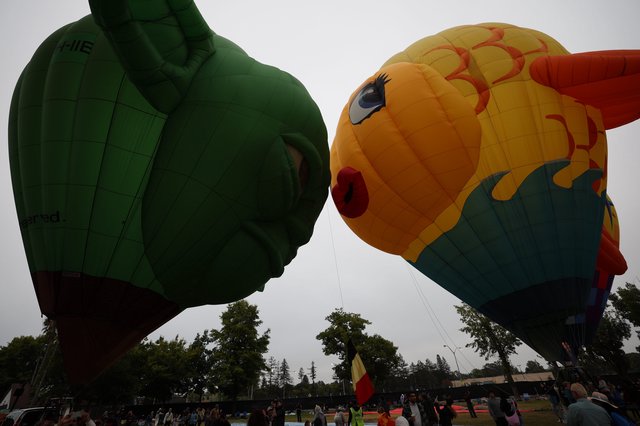 Two Giant Character Balloons Kiss at Hot Air Festival