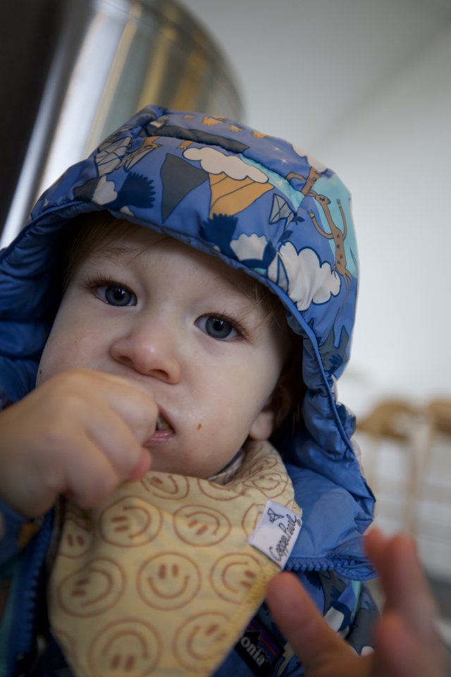 Toddler with Messy Face Eating at Restaurant