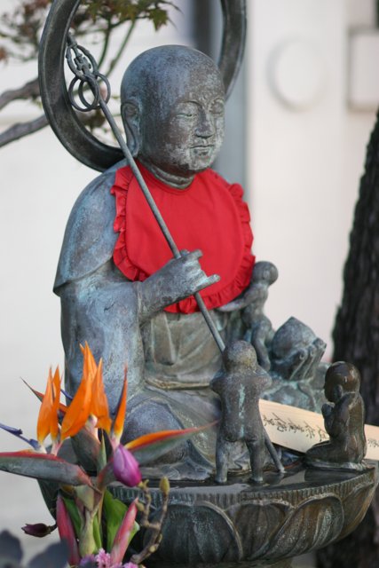 Buddha Statue Adorned with Flower Arrangements