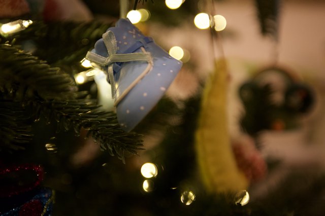 Blue Gift Ornament on Illuminated Christmas Tree
