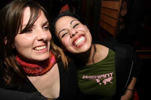 Two Friends Laughing Together at a Night Event
