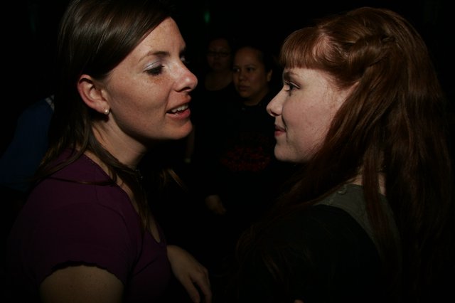 Two Women in Conversation at a Nightclub Event