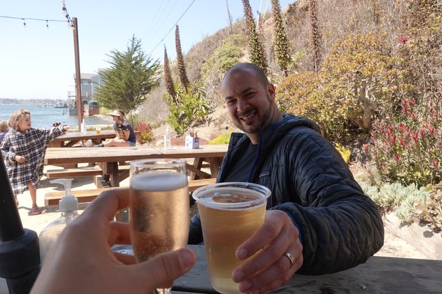 Friends Toasting Beers at Coastal Restaurant