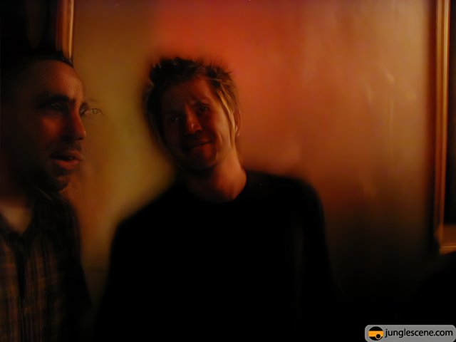 Two Men in a Dimly Lit Room