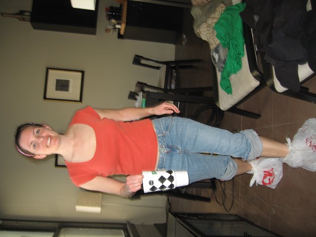 Smiling Woman with Bags on Feet in Apartment