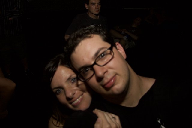 Friends Pose Close Together at Nighttime Event