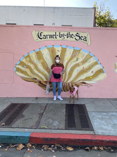 Pink Lady in Front of Seashell Mural