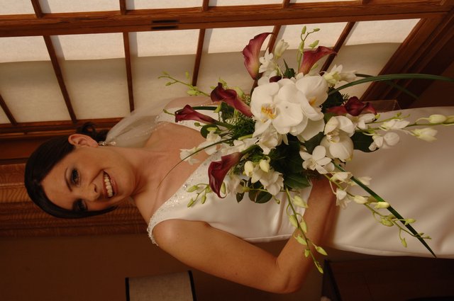 Radiant Bride Holding Elegant Wedding Bouquet Indoors