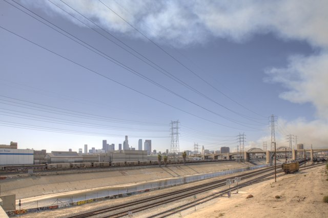 Train passing through city with smoke