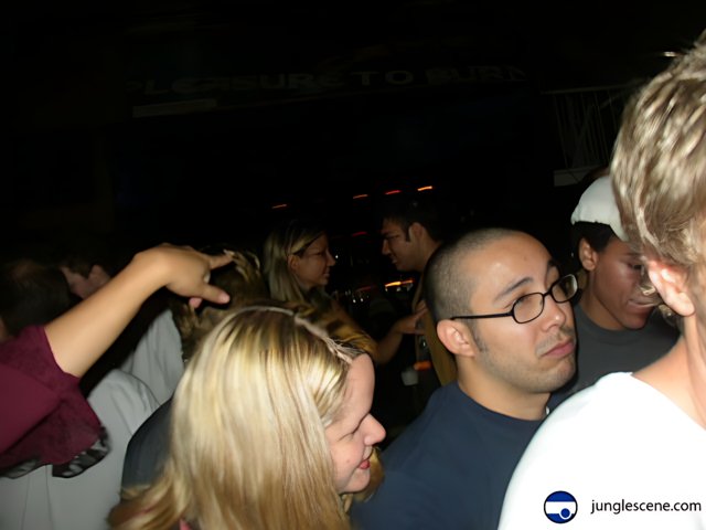 Nightclub Crowd with Man in White Shirt