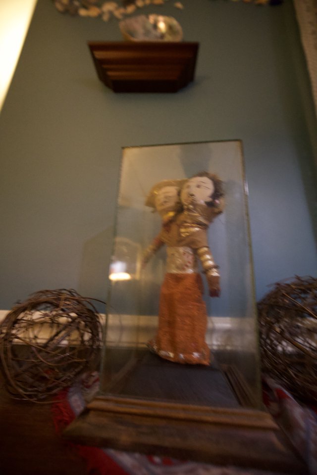 Asian Figurine Display with Decorative Spheres