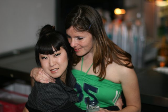 Two Friends Share a Warm Embrace at Night Event