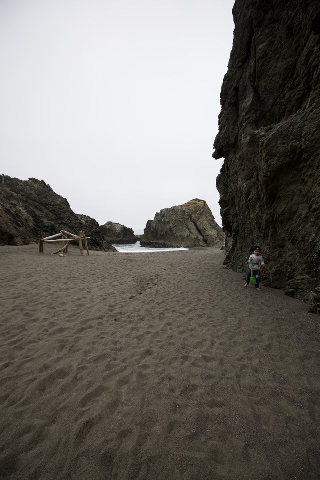 Child Explorer in a Secluded Rocky Cove Beach
