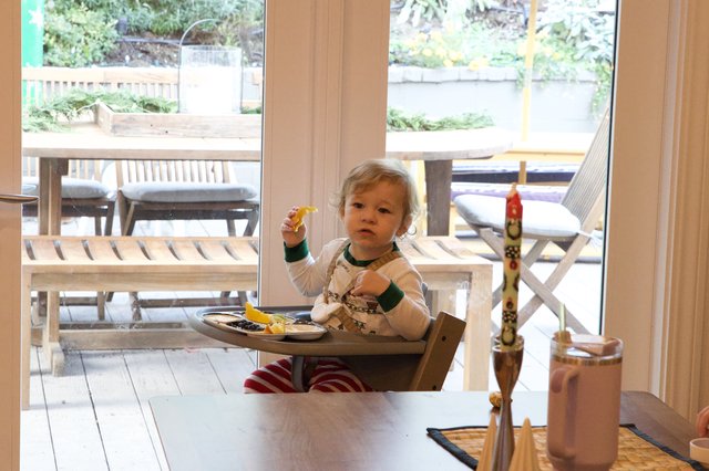 Toddler Enjoying Christmas Eve Breakfast at Home
