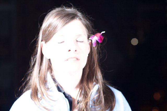Serene Woman with Pink Flower in Hair