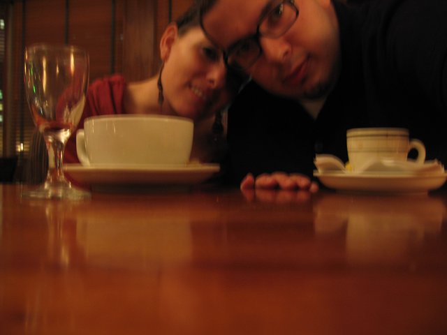 Couple Leans In Close at Cozy Restaurant Table
