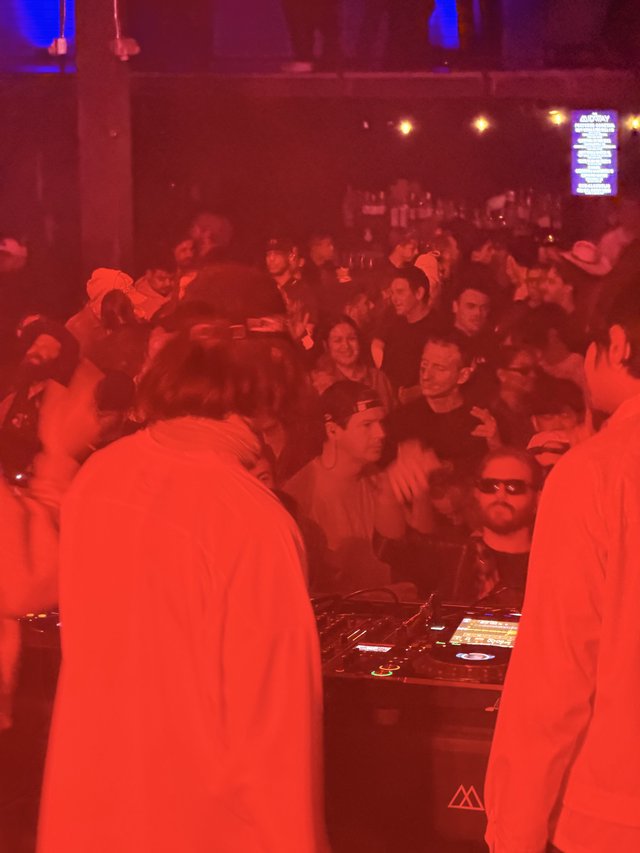 Red-Lit DJ Set at Electronic Music Event
