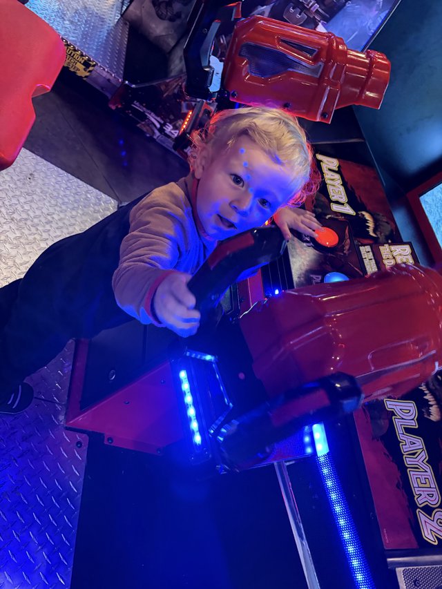 Young Child Playing at Arcade Gaming Station