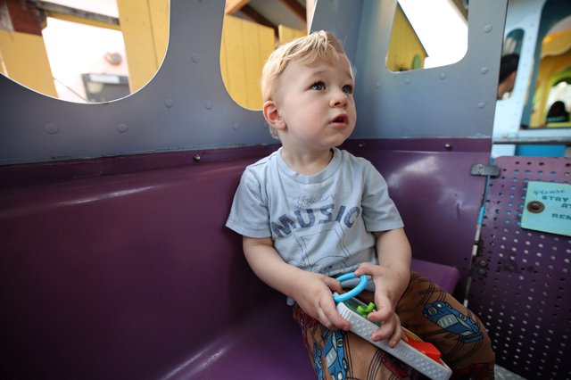 Young Child Gazing Upward in Colorful Play Area