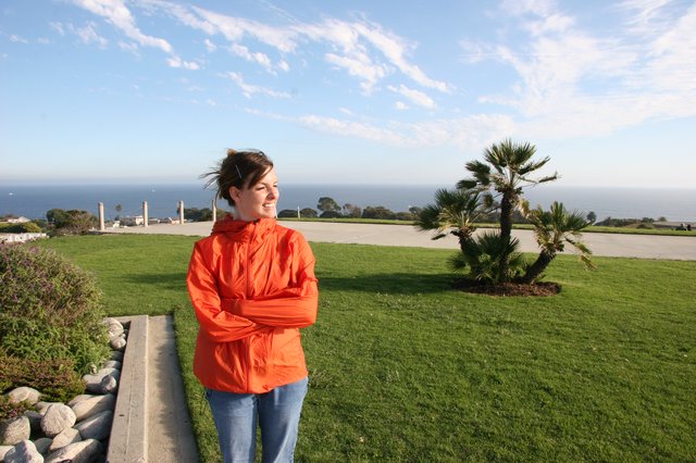 Smiling Woman at Coastal Overlook on Windy Day