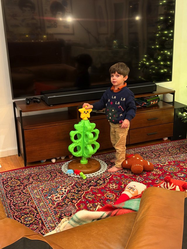 Young Boy Playing with Bright Green Toy Tower
