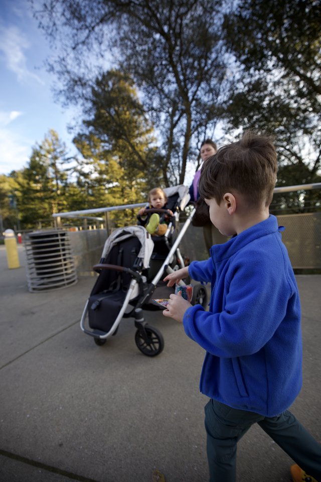 Young Boy at Outdoor Play Area with Family