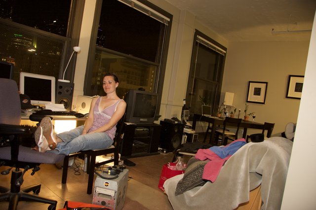Woman Relaxing in Urban Loft Apartment at Night