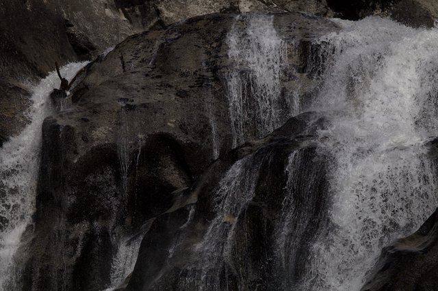 Kayaker Navigating Powerful Winter Waterfall in Yosemite