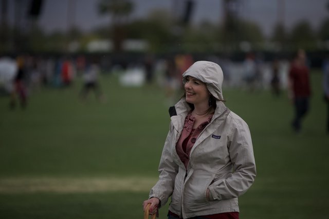 Woman Smiling at Coachella Festival in Rainy Weather
