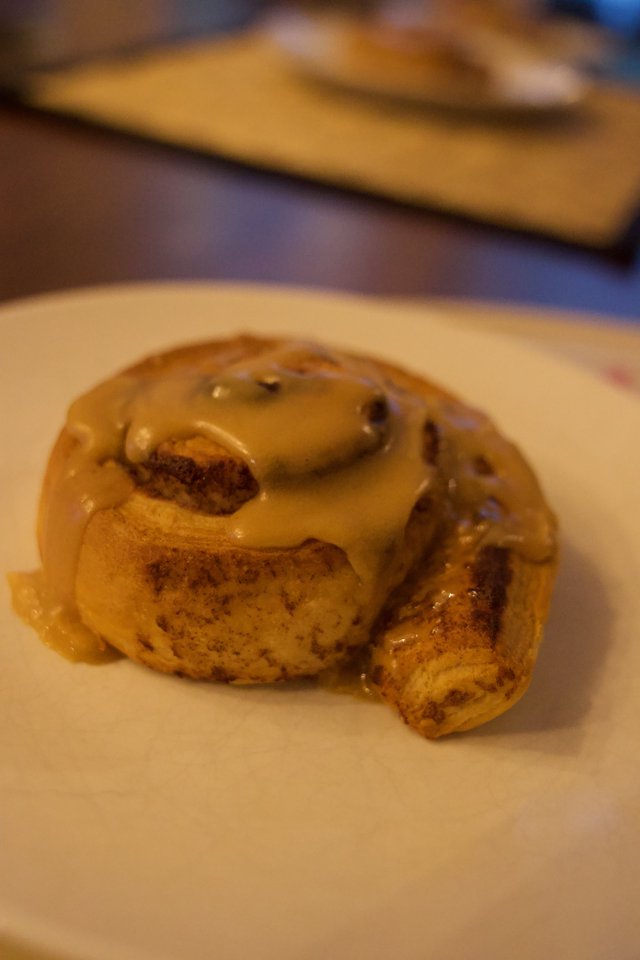 Glazed Cinnamon Roll on White Plate