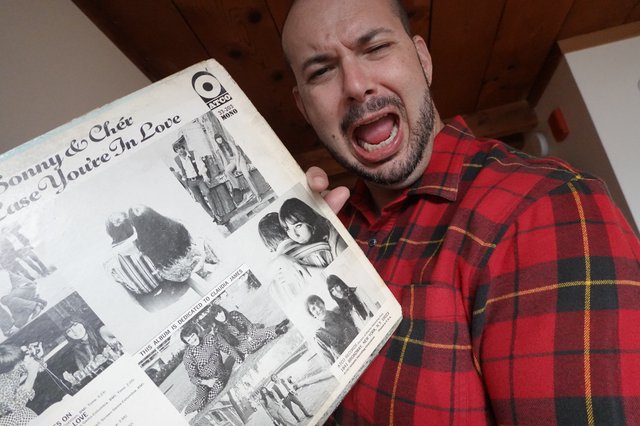 Excited Man Shows Off Vintage Record Album