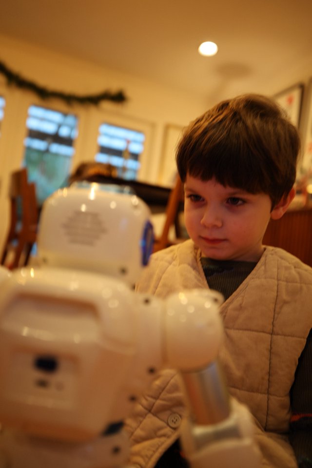 Young Boy Building White Robotic Toy at Home
